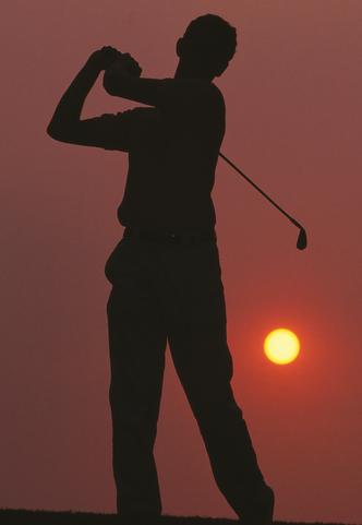 Setting Sun and Golfer in Action