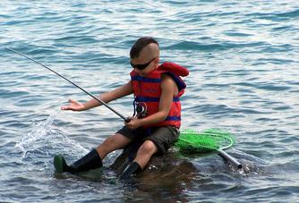 A Boy with Life Jacket Fishing in Lake Rayburn