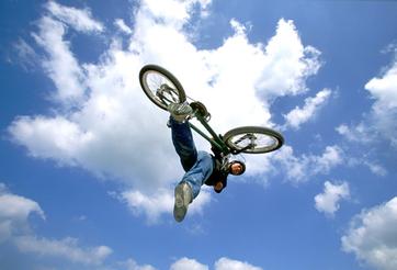 Young Man Performing Stunt on Bike