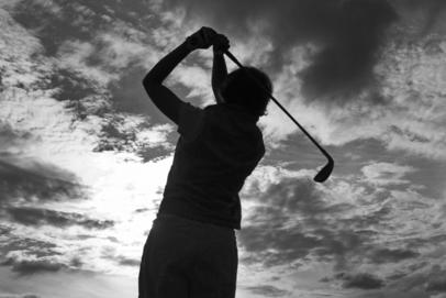 Golf Club, Golf Player and Dark Clouds in the Sky