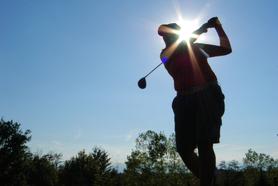 Sparkling Sun on Back of the Golfer in Action